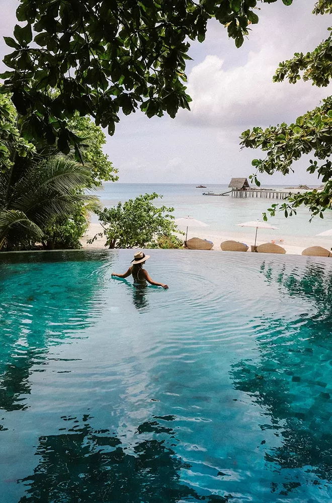 Women in the pool looking at sea view