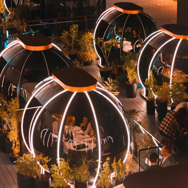 A chandelier elegantly illuminates a dining table in a sophisticated restaurant setting.
