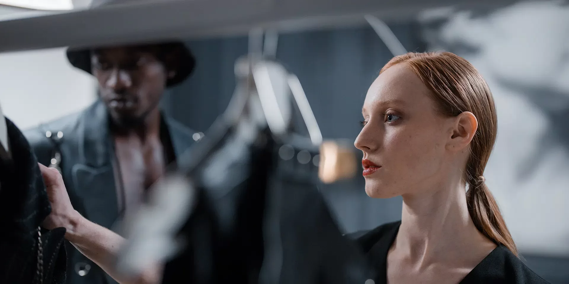 Women and man looking through clothing rail