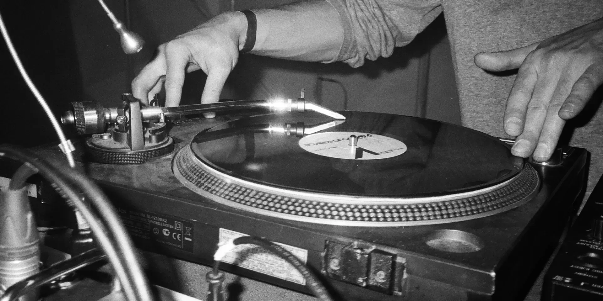 Black and white photo of person using dj decks