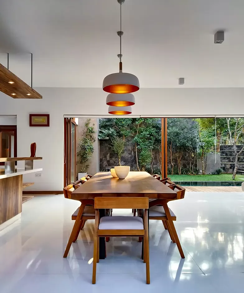 A contemporary dining room featuring a spacious table surrounded by elegant chairs, showcasing a stylish and inviting atmosphere.