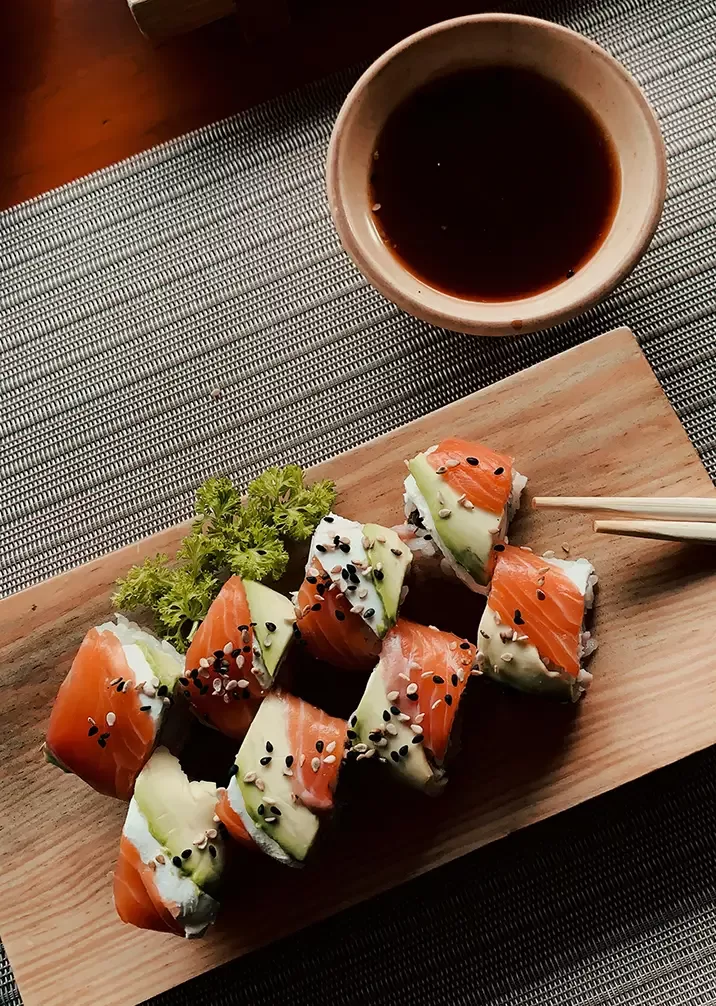 An elegant display of assorted sushi rolls and sashimi, artfully presented with fresh ingredients and colourful garnishes.