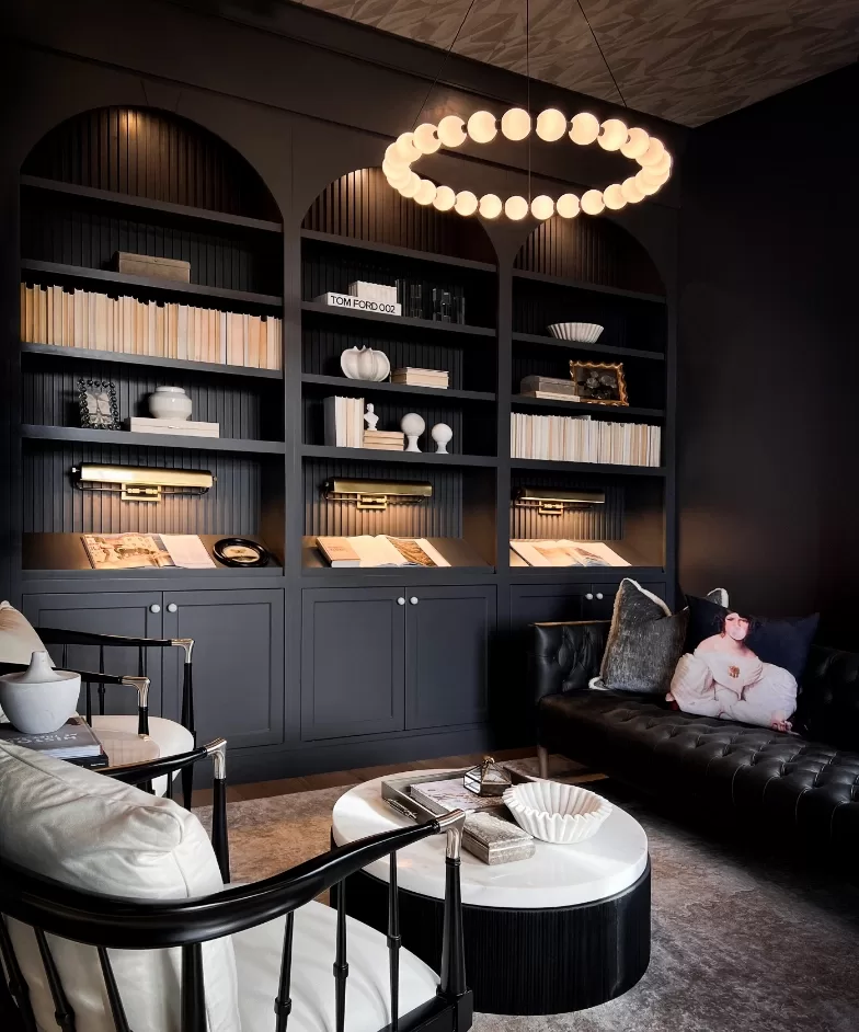 A black and white living room featuring a stylish round chandelier hanging from the ceiling, creating an elegant ambiance.
