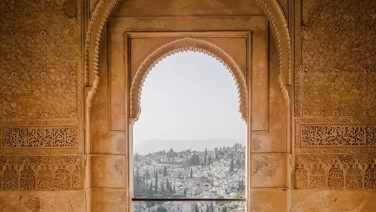 Arched ancient wall with view of city