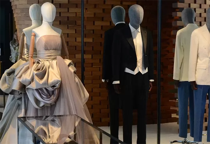 High fashion clothing on mannequins in front of a mirror