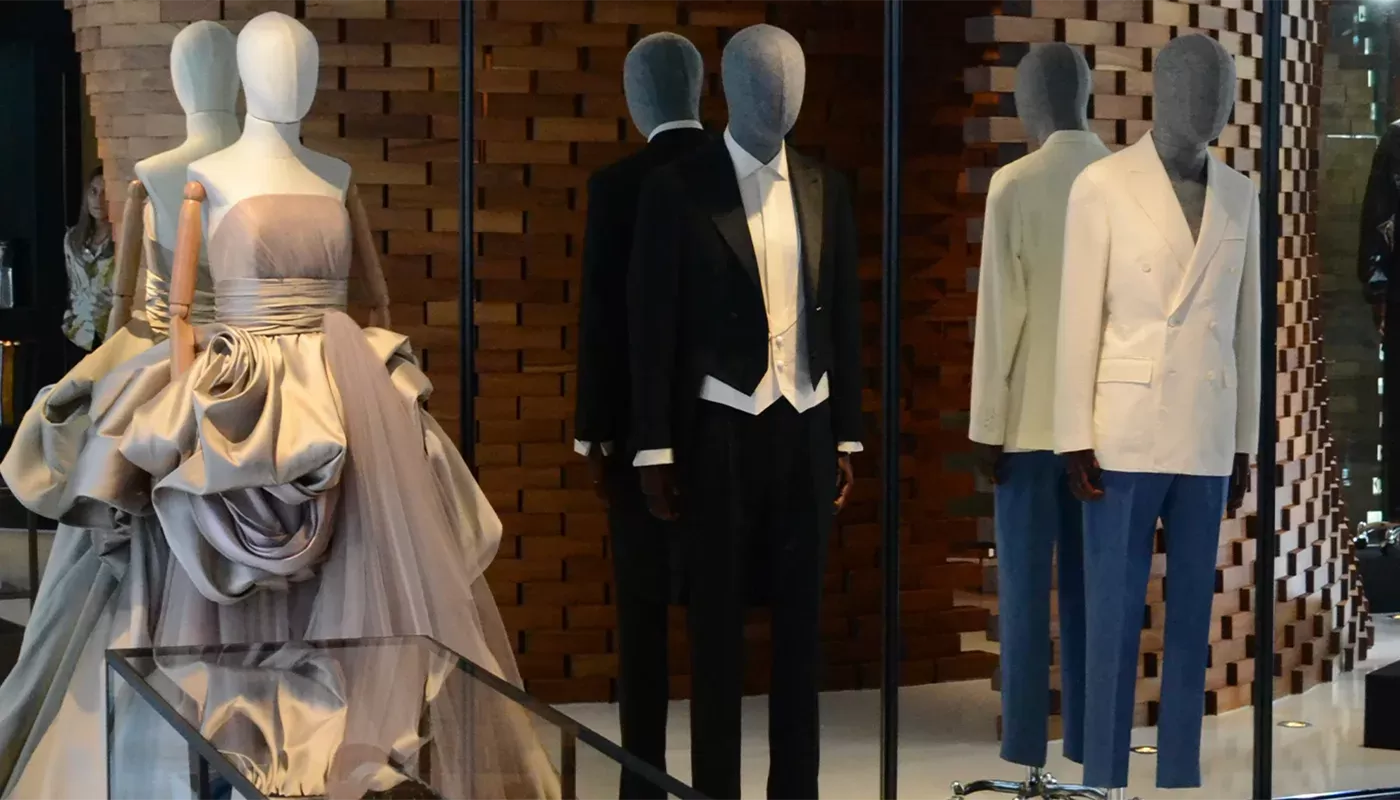 High fashion clothing on mannequins in front of a mirror