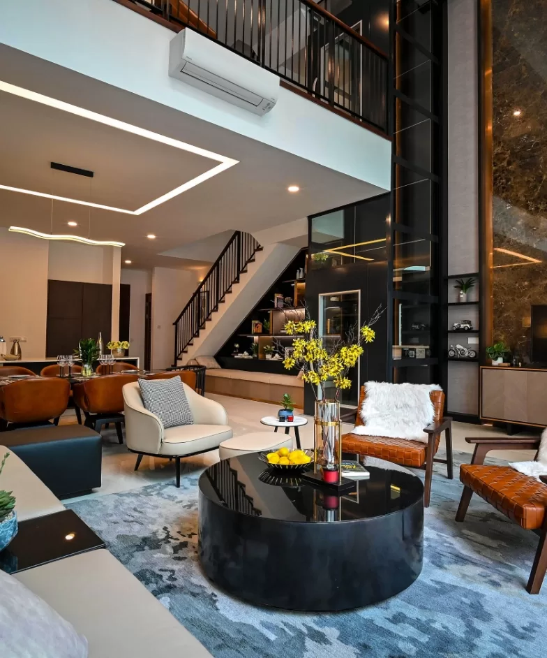 A contemporary living room featuring a stylish staircase, showcasing modern furniture and elegant décor elements.