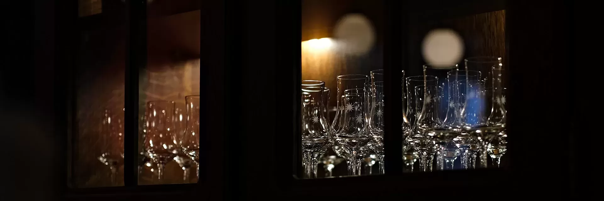 Cabinet of Hennessy glasses.