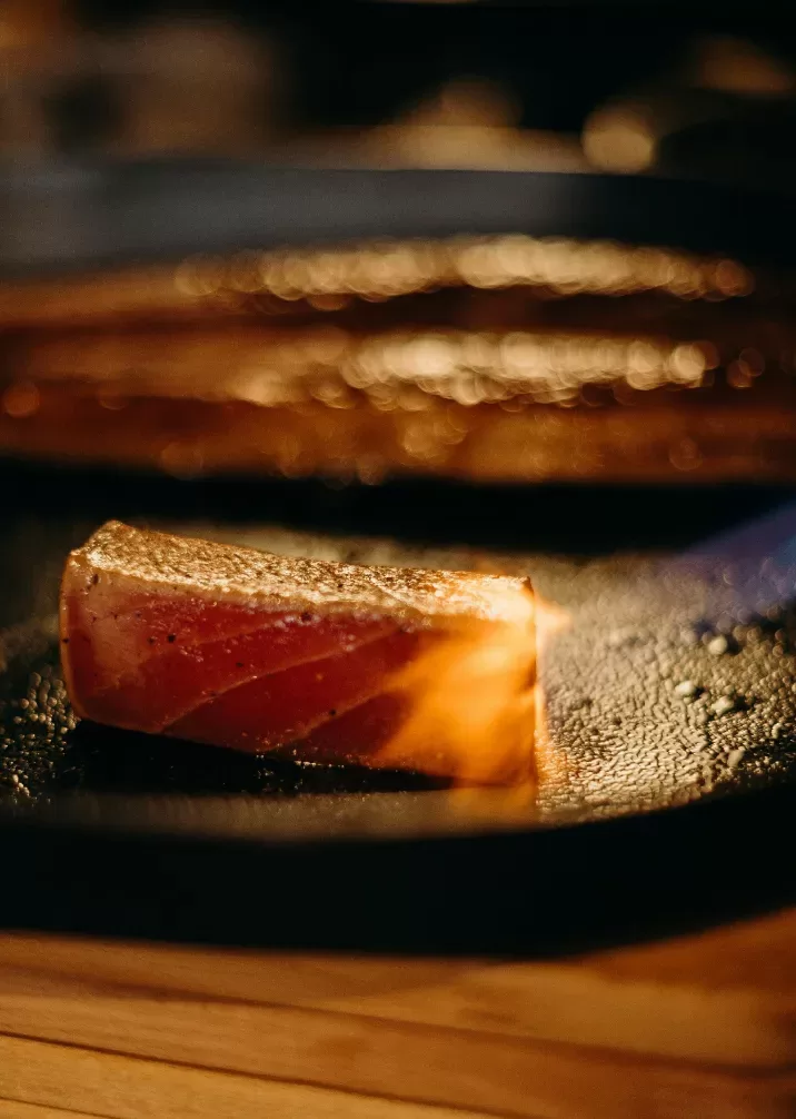 A dessert served on a slate grey plate on a wooden countertop.