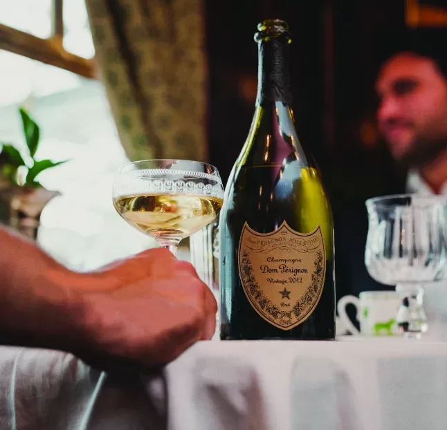 A person holds a bottle of champagne, showcasing a moment of celebration and joy.