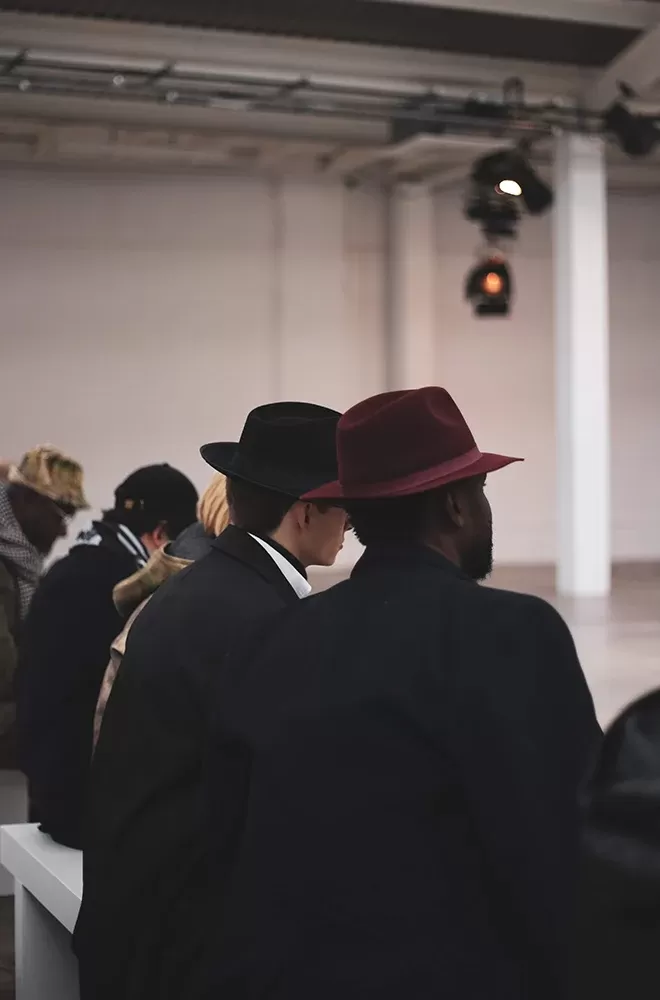 People sat on benches at catwalk show