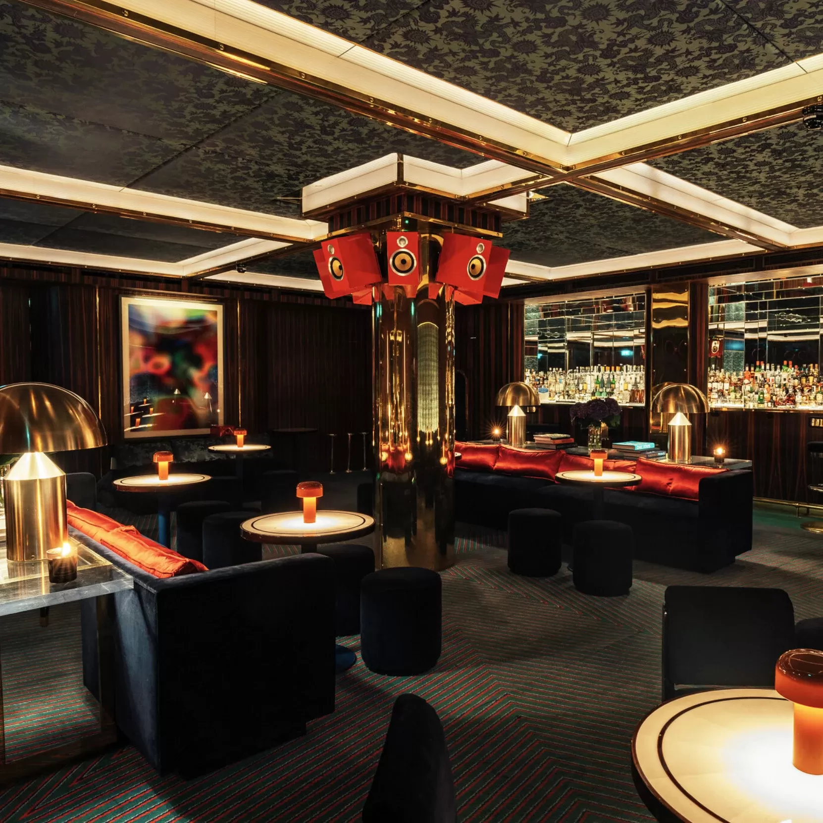 Fancy elevated living room-style interior with carpeted floors, navy velvet sofas and mirror-topped tables interior at The Dragon Room at Isabel, Mayfair, London