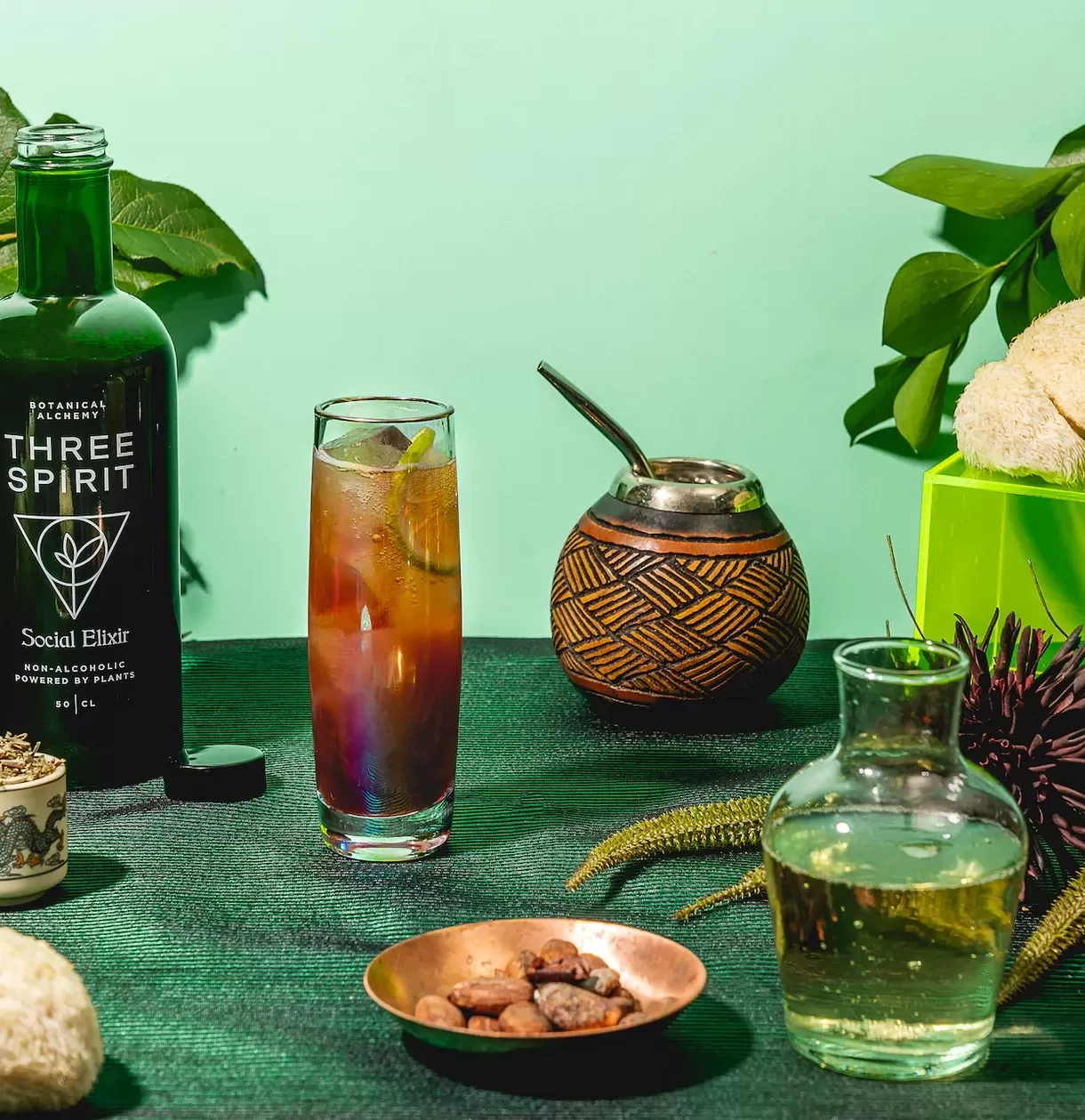 Vegan restaurant Farmacy's nootropic mocktail collaboration with Three Spirits served in bottles and glasses on green background