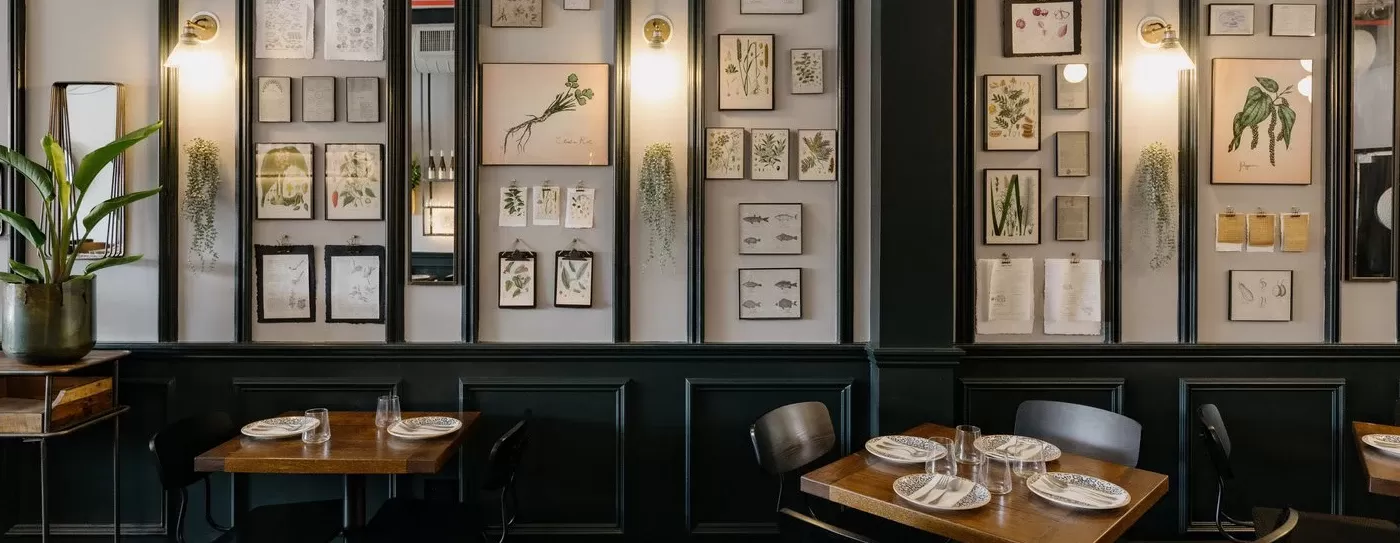Retro chic interior with framed photos placed all over the walls at KRU, Williamsburg, USA