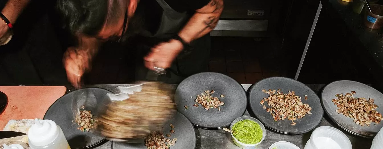 Action shot of chef plating up dishes at LORE Park Slope, Brooklyn, USA