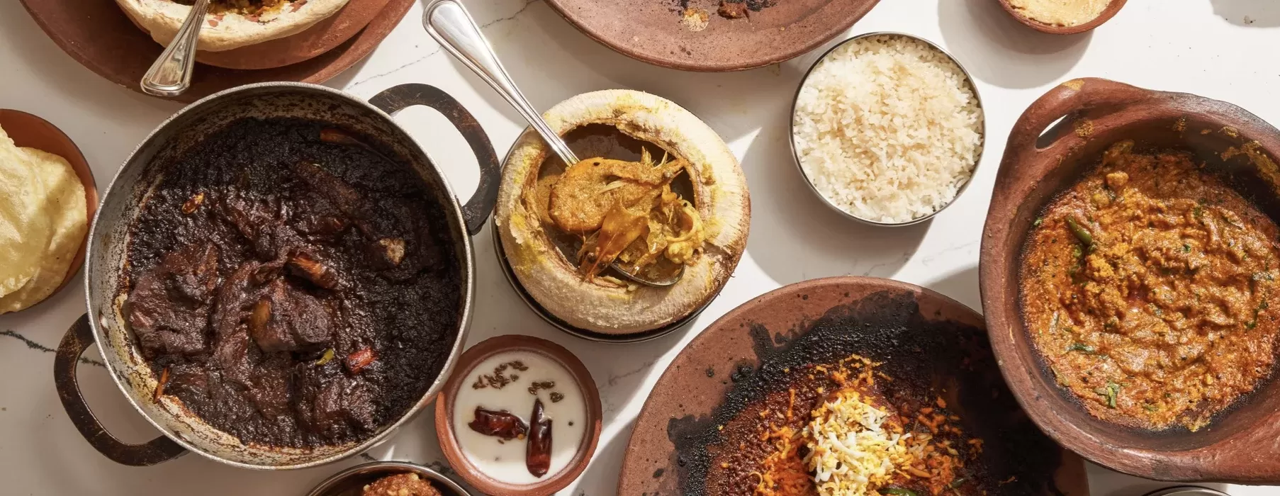Birdseye view of selection of authentic Kolkatah cuisine served in clay dishes at 5. Masalawala & Sons, Park Slope, Brooklyn, USA,