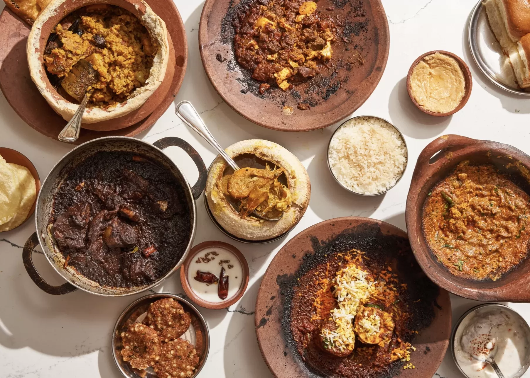 Birdseye view of selection of authentic Kolkatah cuisine served in clay dishes at 5. Masalawala & Sons, Park Slope, Brooklyn, USA,