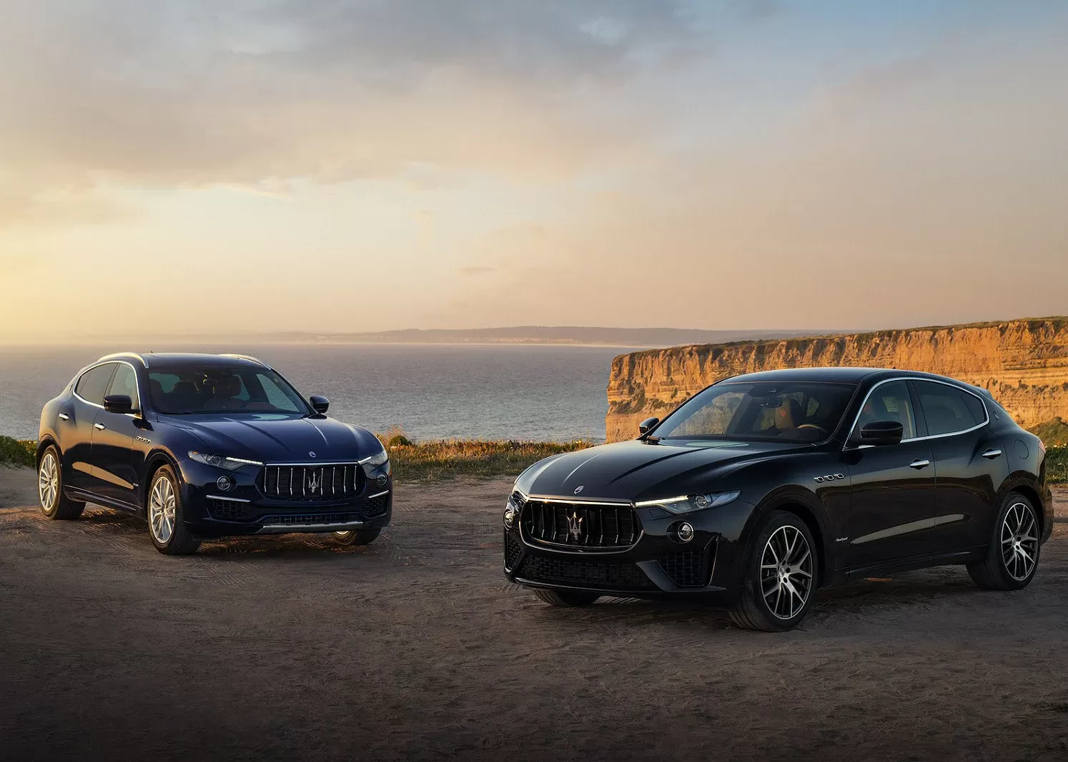 Two Maserati Levante Hybrid parked on top of a cliff