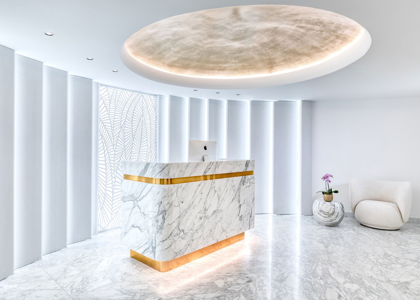 Grand circular shaped room with marble floor and marble and gold reception desk at the Matild Spa, Budapest