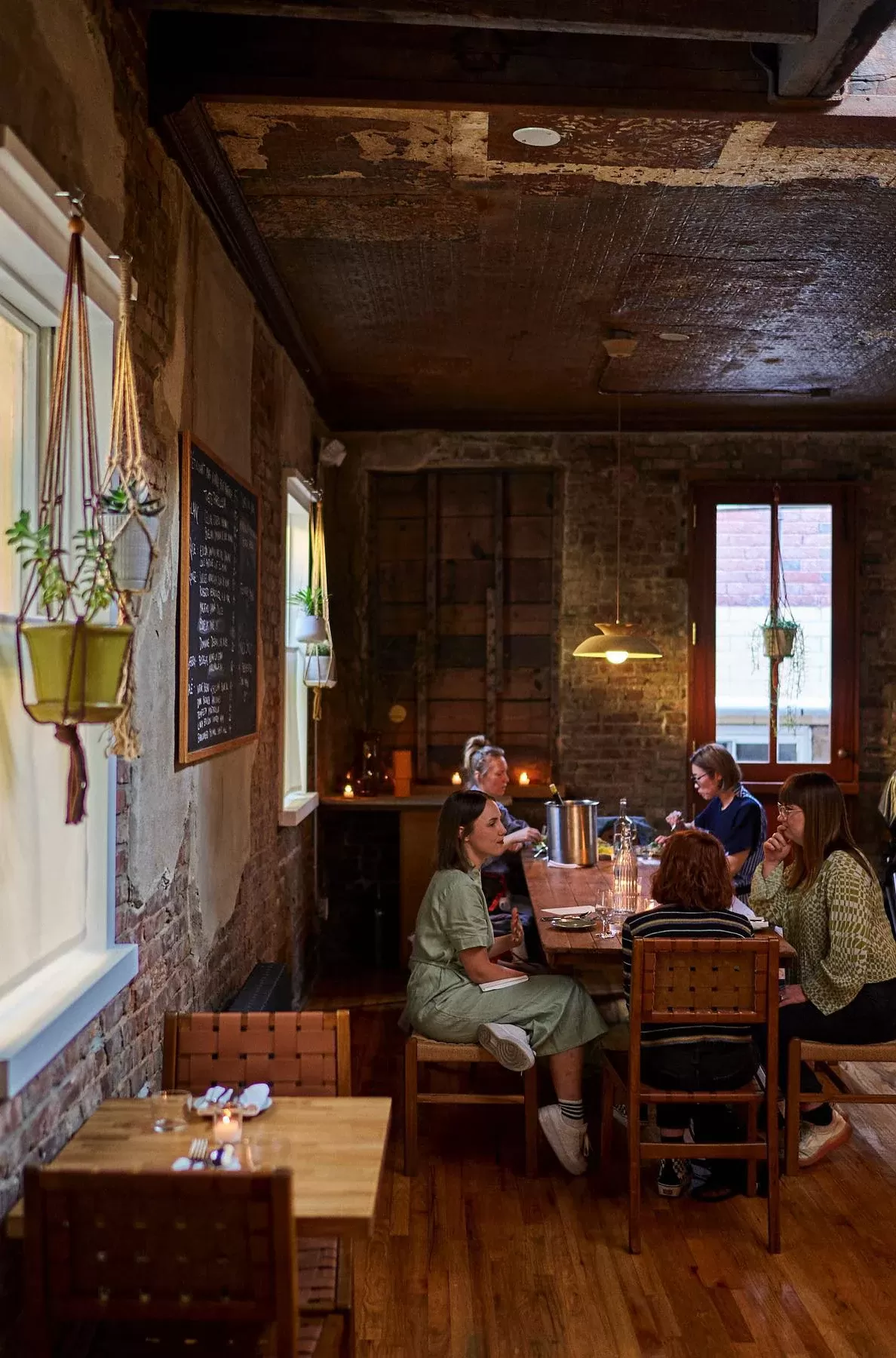 Group of people inside of rustic seafood restaurant Place des Fêtes Clinton Hill, Brooklyn, USA