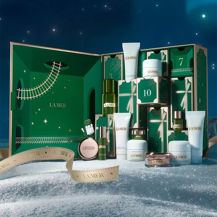 The La Mer Wonder Express Advent Calendar shot on a glittery draped white floor with blue background.